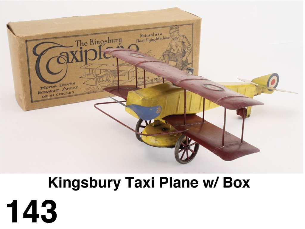 Kingsbury Taxi Plane w/ Box: painted pressed steel with wind up mechanism with very crisp illustrated box; very nice example that would benefit from professional cleaning Size: 16" l., 12" ws.