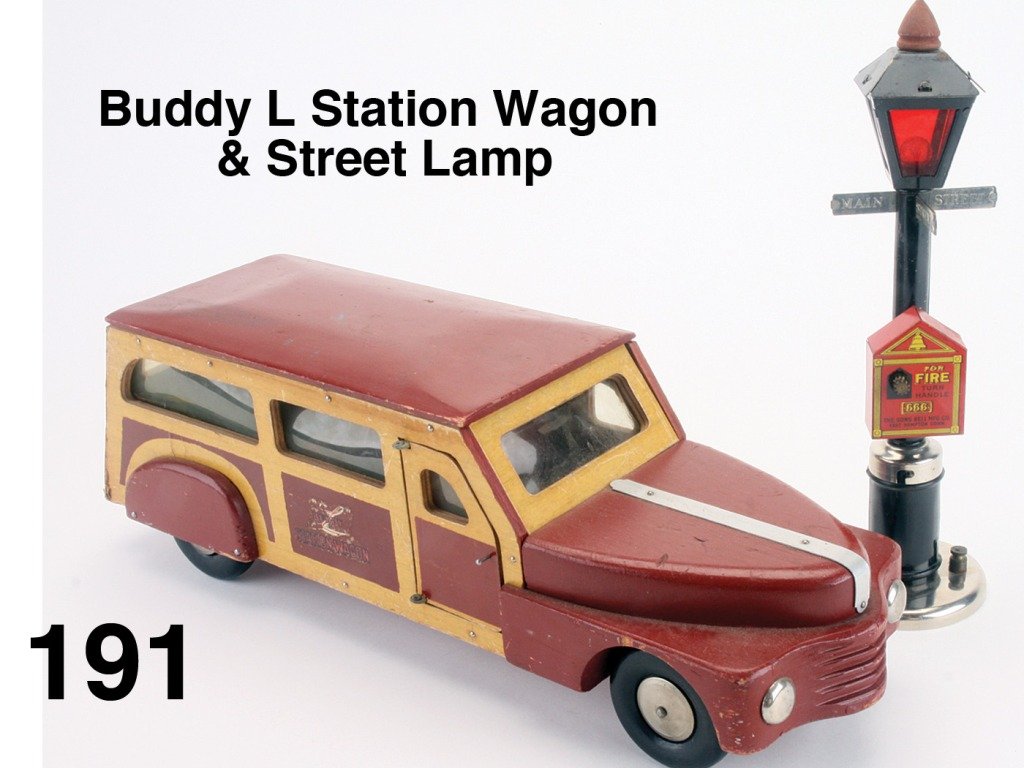 Buddy L Station Wagon & Street Lamp: painted maroon colored wood with faux grain paper on wood trim and edging; featuring 2 side opening doors and large rear panel, celluloid windows and black wooden wheels offered with Gong Bell Mfg. Co