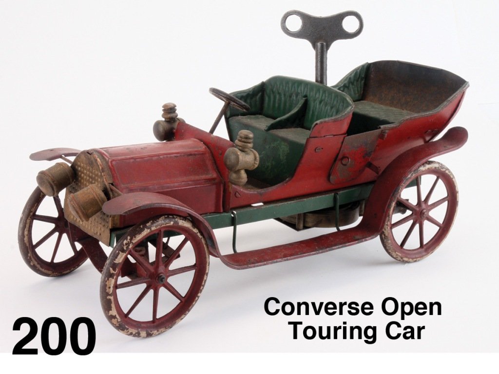 Converse Open Touring Car: painted heavy tin, clockwork, nice detail includes wooden side and head lamps, 'tufted' seats, cast wheels, operating steering Size: 15.5" l.