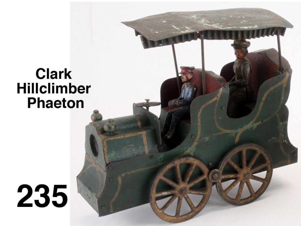 Clark Hillclimber Phaeton: early and scarce circa 1897 painted steel and wood friction auto with crimped tin fringe top and painted cast iron passenger and driver Size: 10.5" l.