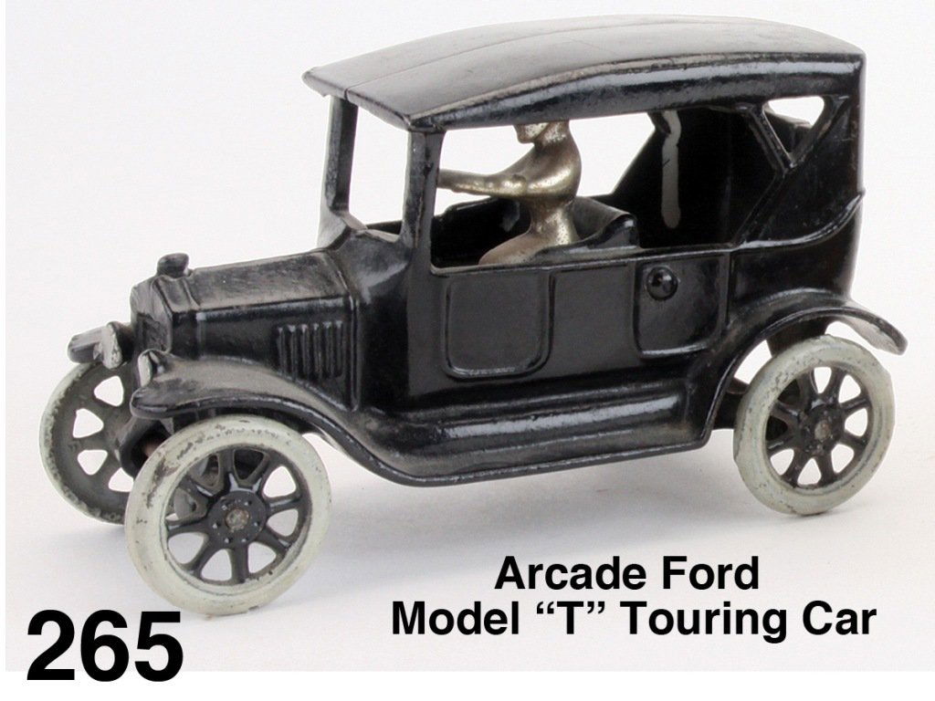 Arcade Ford Model 'T' Touring Car: painted cast iron, casting simulates soft top touring model, offered with original nickel plated driver and painted spoke wheels with gray painted tires, an above average example Size: 6.5" l.