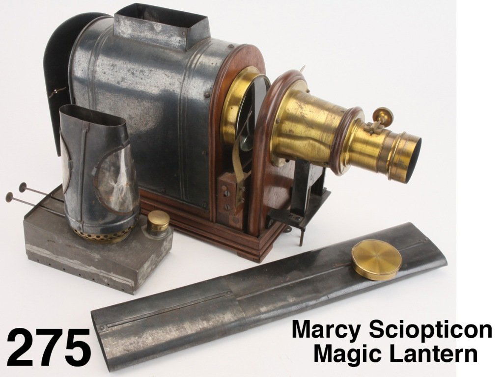 Marcy Sciopticon Magic Lantern: appears complete and functional, has wood base with gun metal tin burner housing, heavy brass mounted lens with worm gear focusing, double wick burner mounted on fuel reservoir with brass cap inscribe