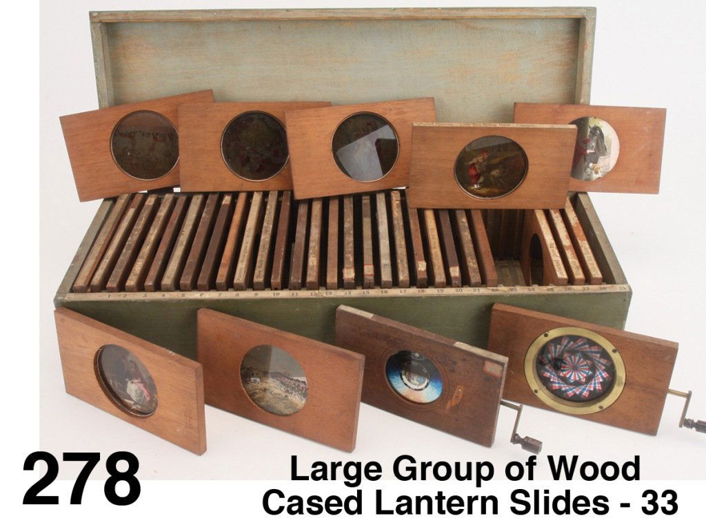Large Group of Wood Cased Lantern Slides - 33: many marked McAllister Optician NY with paper titles: Christmas tree, Little Red Riding Hood, Battle of Big Horn, etc.; offered along with crank operated kaleidoscope slide and a boxed set of 21 simil