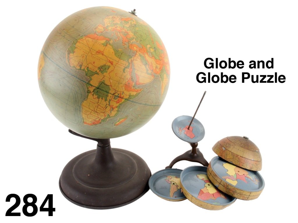 Globe and Globe Puzzle: an unusual globe on metal base depicts climactic zones and ocean currents rather than nation states, offered along with a section puzzle in form of paper covered plastic globe - sections show the cont