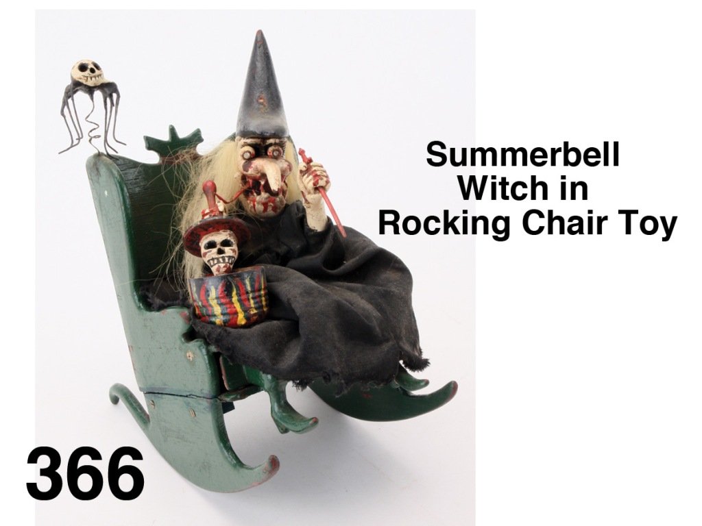 Summerbell Witch in Rocking Chair Toy: cloth dressed carved wood figure in painted wood rocking chair with two internal clockwork mechanisms which cause witch to stir pot, lift lid showing scull, and rock back and forth; the other animates