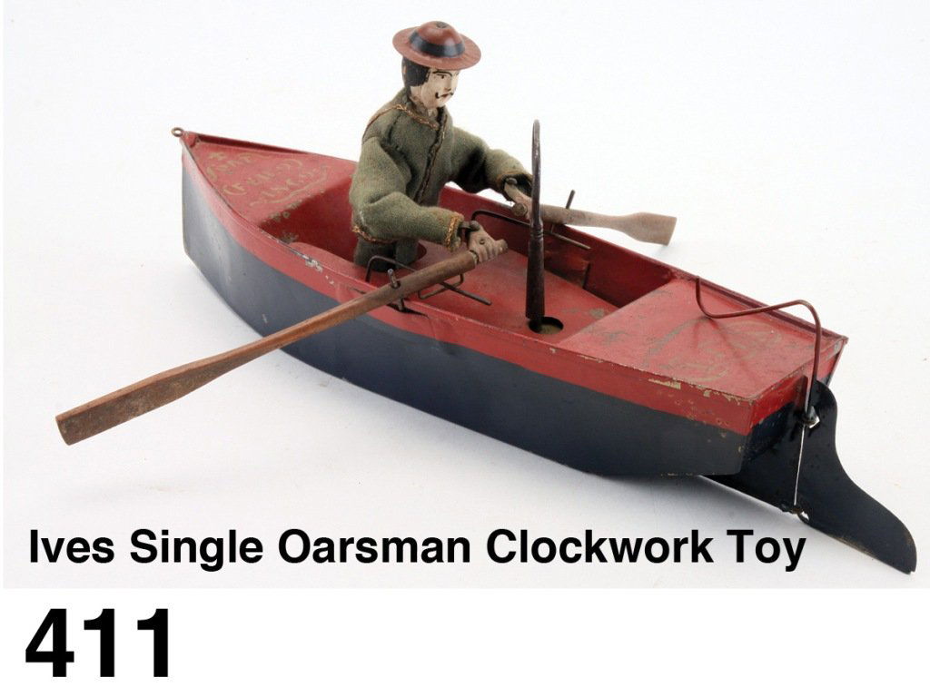 Ives Single Oarsman Clockwork Toy: a cloth dressed wood and metal figure realistically rows the painted tin boat, on the prow is stenciled the patent date 'Feb. 9, 1869' a classic Ives toy offered in a finely and correctly restored sta