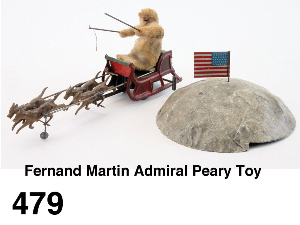 Fernand Martin Admiral Peary Toy: painted tin with cloth dressed figure driving clockwork sleigh pulled by 4 dogs around the North Pole, a scarce Martin historical toy Size: sleigh 8" l. overall