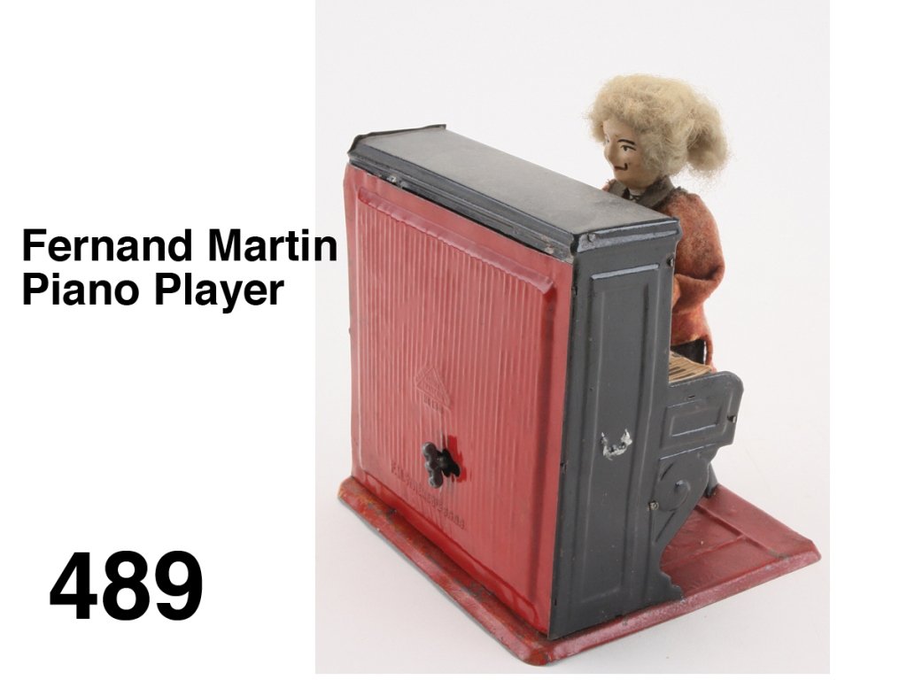 Fernand Martin Piano Player: cloth dressed painted tin figure seated at piano with candelabra and music sheet, clockwork in piano causes man to play plink-plunk music; figure retains nice paint on face and all original clothing S