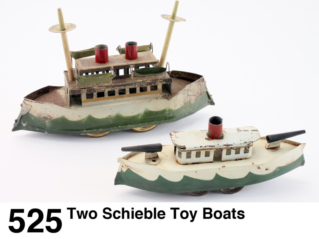 Two Schieble Toy Boats: painted heavy tin with inertia wheel friction drive, a nice pairing showing different sizes, the smaller version is relatively scarce and in above average condition Size: 10" & 12.5" l.