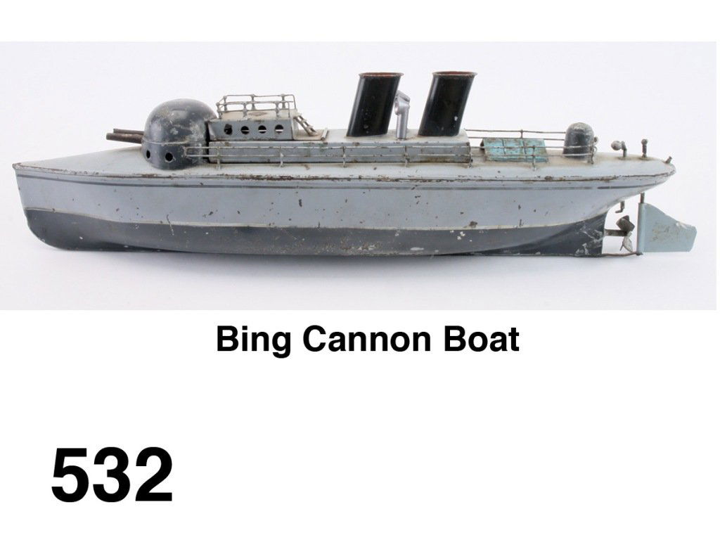 Bing Cannon Boat: painted tin gun boat with 2 firing cannon that when fired should turn the rudder so boat changes course - internal mechanism appears complete but replaced rudder does not engage properly, retains make