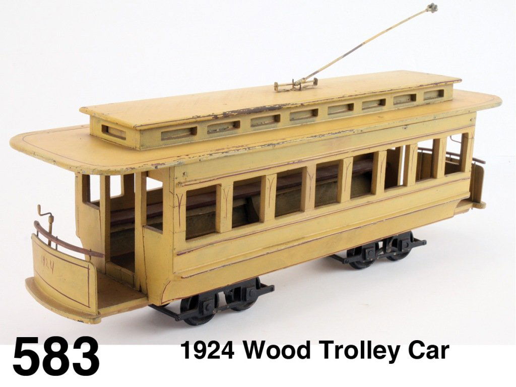 1924 Wood Trolley Car: nicely crafted painted wood folk art styled trolley with lift off roof and interior long bench seating; fine maroon pin striping and dated 1924 at either end Size: 22.5" l.