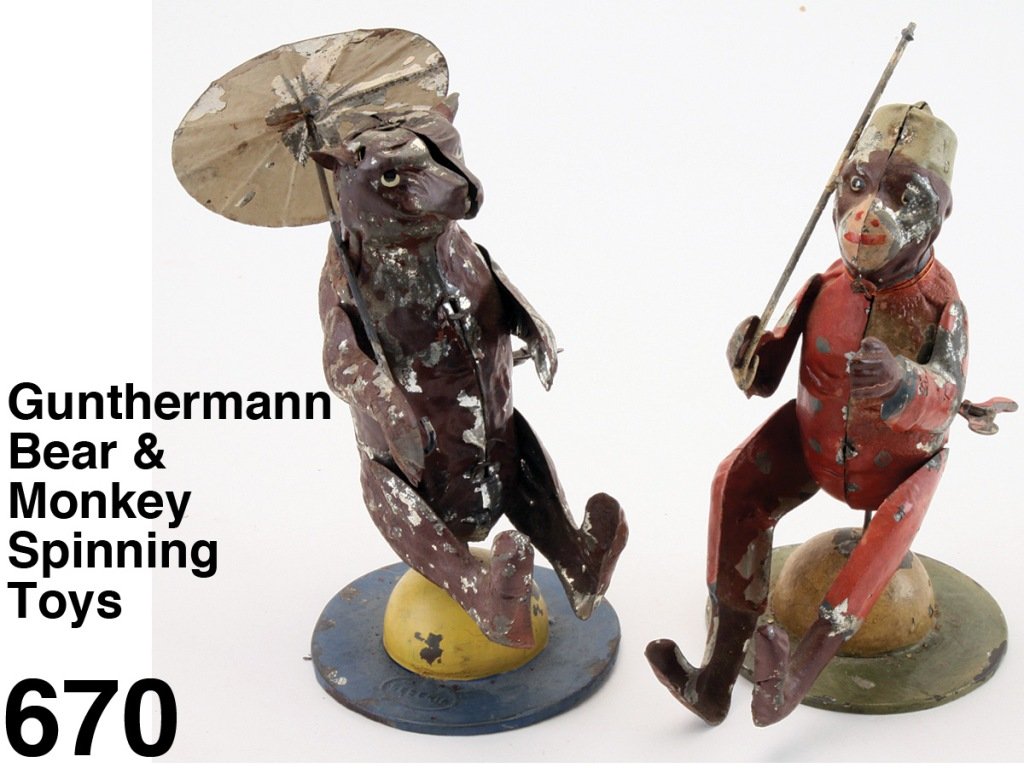 Gunthermann Bear & Monkey Spinning Toys: painted tin figures with internal clockwork mechanism - each is seated on a dome and they spin around, bear holds colorful umbrella while monkey is missing his and his mechanism does not work Size: 7"