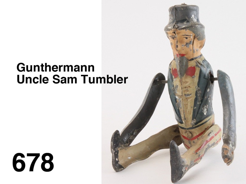 Gunthermann Uncle Sam Tumbler: painted tin with internal clockwork mechanism wound by turning arms - it then does somersaults Size: 8" t.