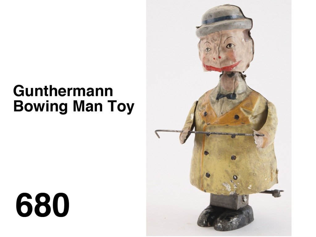 Gunthermann Bowing Man Toy: painted tin with internal clockwork, he holds his cane and bows as head rocks to and fro Size: 8" t.
