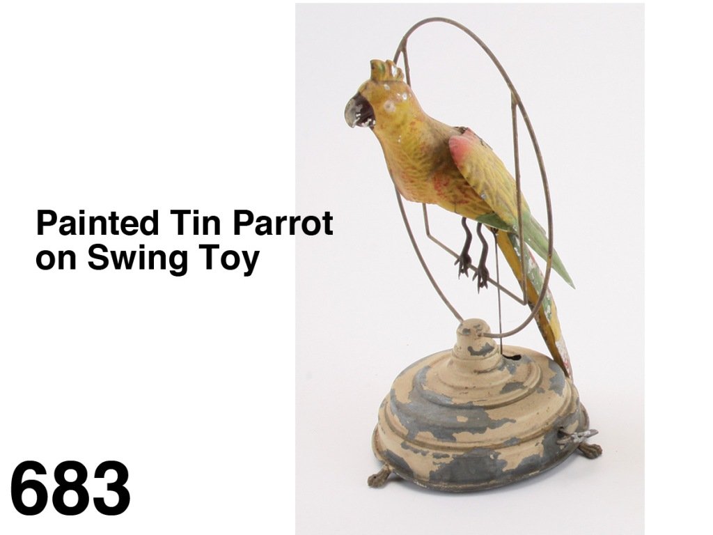 Painted tin Parrot on Swing Toy: colorful painted tin clockwork toy, probably by Gunthermann, bird rocks back and forth flapping wings, impressive scale Size: bird 11" l.