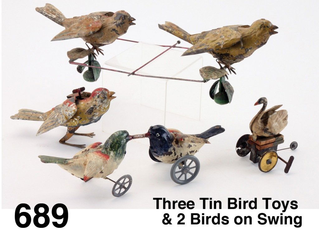 Three Tin Bird Toys & 2 Birds on Swing: colorful painted tin clockwork toys, probably by Gunthermann, includes pair fighting over worm, flapping wing jumper, and swan on wheels with bellows; along with a pair of birds on swinging armature -