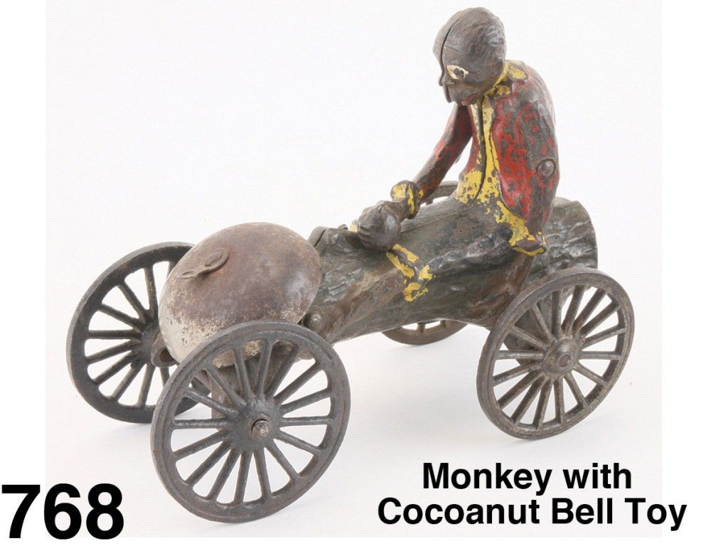 Monkey with Cocoanut Bell Toy: painted cast iron, a clever animated bell toy - monkey continually bangs nut on log as toy is pulled Size: 6.25" l.