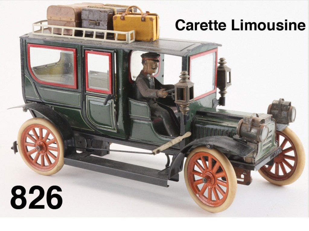 Carette Limousine: painted and lithographed tin limousine with painted tin driver, robust clockwork mechanism, rubber tired wheels, beveled glass throughout, operating rear doors, headlamps and side lamps, offered with