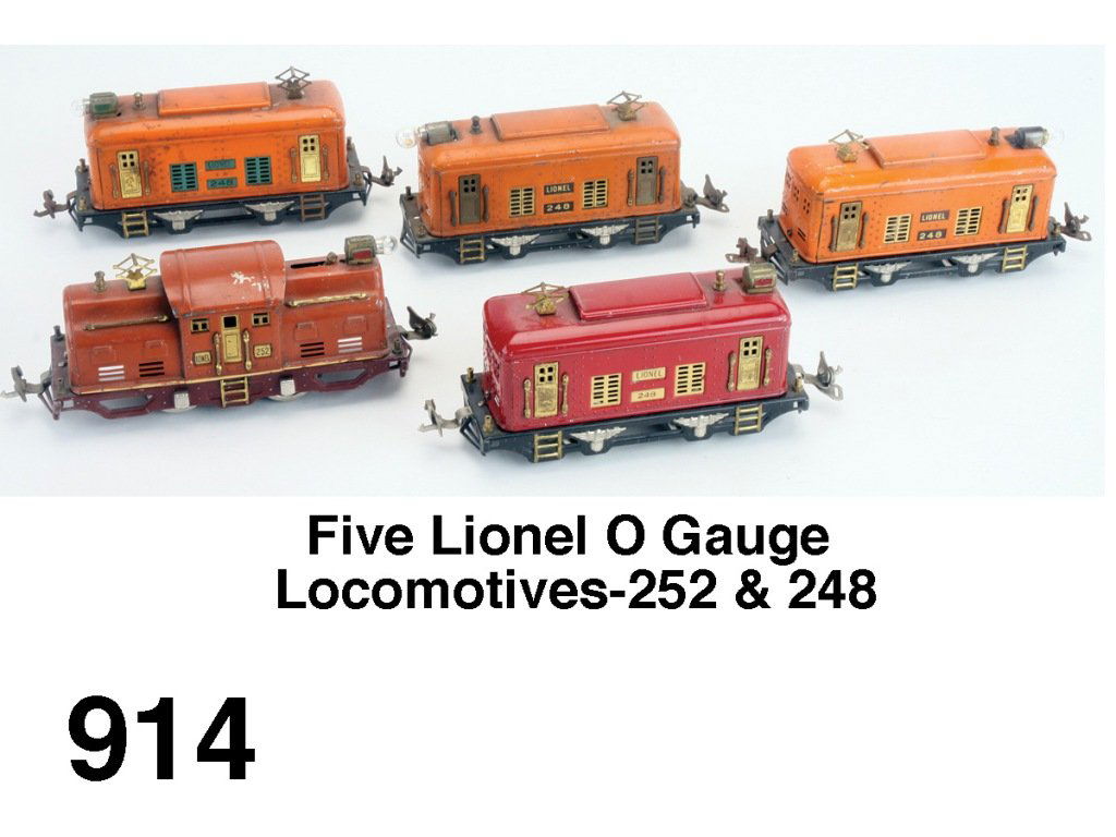 Five Lionel O Gauge Locomotives-252 & 248: electric outline electric engines- 248 maroon & cream engine, 252 terra cotta with cream stripe, two 248 orange locos and 248 orange and green loco Size: appr. 7.5" l.