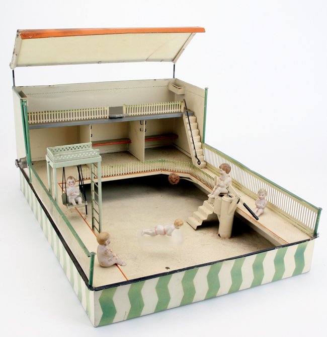 Swimming Pool Pavilion: painted and stenciled tin structure enclosing a large swimming pool with fenced walkways, changing rooms, and an upper deck with diving board; shading the upper deck is a slanted milk glass canopy; am