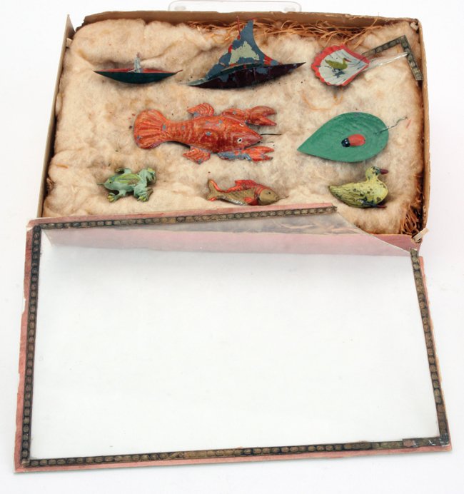 A Boxed Group of Floating Water Toys: these painted tin toys were designed for water play; included are 2 boats - 1 with passenger, a scallop shell with bird, and a leaf with lady bug - all molded to float while the animals: a lobster, fr