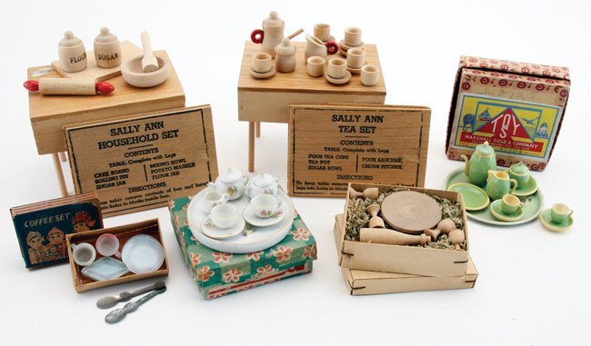 Boxed Wood & China Tea & Household Sets: Sally Ann turned wood tea and households sets where box bottom becomes a table, German turned wood wine set, 10 piece china tea set in lithographed paper box, German painted tin and wood tea set in or