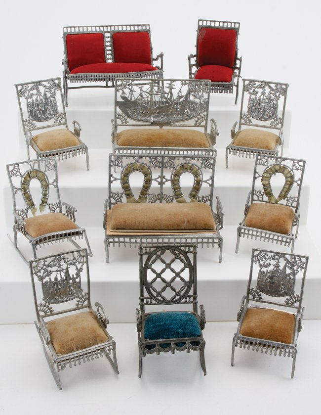 Adrian Cooke Soft Metal Furniture: American, circa late 19th century, soft white metal alloy group includes settee, rocker and chair from the Fairy series; sofa, rocker and 3 side chairs with Columbian Exposition imagery, a less common