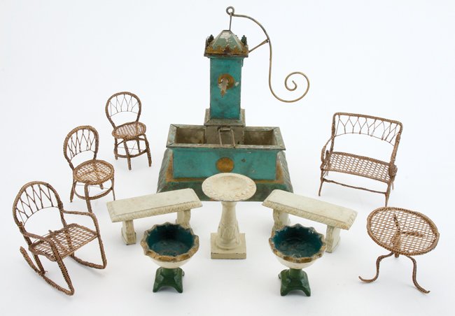 Miniature Garden Accessories: outdoor grouping includes German painted tin fountain with hand pump, 2 painted cast iron jardinieres, 2 slush cast benches and bird bath and 5 piece wicker and wire patio set fountain 7" w. x 8.5" t.