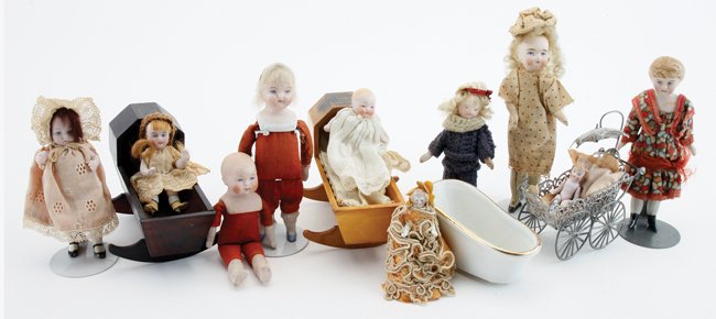 Bisque Dolls, Cradles, etc.: 10 bisque dolls including a young girl with molded hair, 5 jointed bisque infants and little girls, 2 undressed shoulder head dolls (brother and sister), a bisque head doll with jointed wood body and 