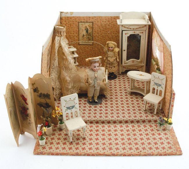 Folding Bedroom Room Box: circa 1920's, lithographed paper covered wood base with heavy card 3 wall surround with window, hand painted wood furniture decorated with floral festoons and sail boat imagery and 2 glass eyed bisque