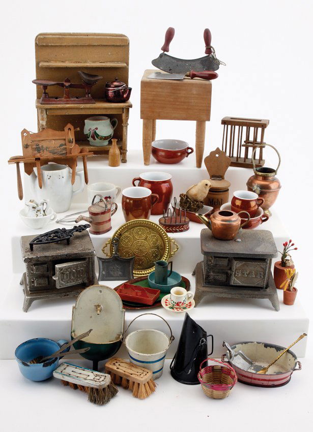 Dolls' House Kitchen Stoves Etc.: various makers, mostly mid 19th to early 20th century, included are "Dot and "Star" cast iron stoves (missing stacks), wooden chopping block, side table with shelf, scuttle, Rock & Graner toast rack,