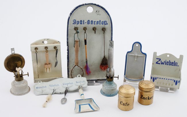 German Tin Kitchen Accessories: Marklin and other makers, 4 wall utensil racks, Zwiebeln (onions) bin, 2 kerosene lamps (1 missing reflector, other with no chimney) and 2 gilt tin canisters largest 3.5" w. x 6.25" t.