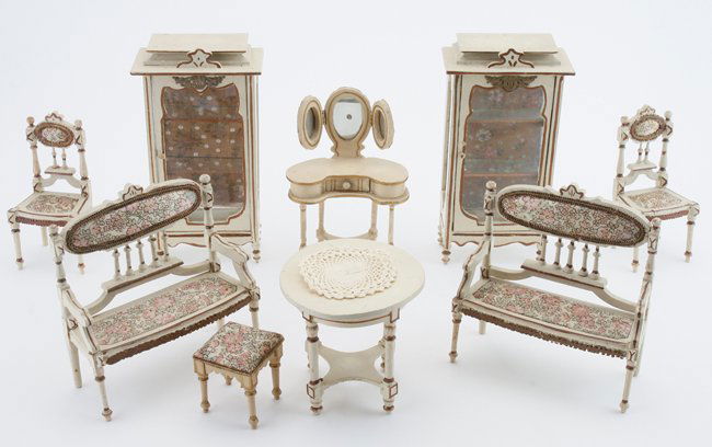 Leonhardt Parlor Suite: early 20th century, white painted wood with floral silk upholstery and gilt edging; suite includes 2 display cabinets with glass shelves and printed crepe lined backs, 2 high back settees, 2 chairs, c