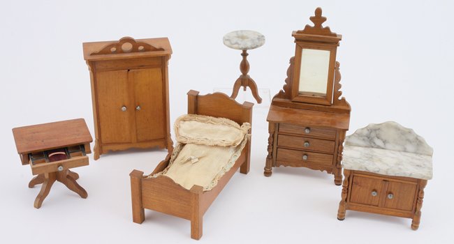 Schneegass Bedroom Suite: German, circa late 1800's, stained wood grouping includes bed, dresser with mirror, wash stand and pedestal table with marble tops, sewing table with compartmented interior, and wardrobe which has ink