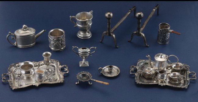 Dolls' House Miniature Silver: included are 11 unmarked tea set pieces of American coin silver: 2 trays, 3 cups, 1 saucer, 2 creamers, open sugar, tea pot and urn; a sterling goblet, strainer with under bowl (all marked sterling),