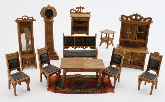 Art Nouveau Parlor/Dining Suite: German, circa 1890's, light stained wood suite with printed decoration and leatherette upholstery: sofa (missing scrollwork from top), side table, hall mirror, tower clock, desk (missing part of top f