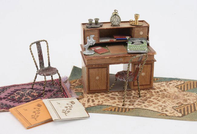 Candy Box Desk with Accessories: lithographed card surprise/candy box with inkwell, candle holder, typewriter 2 painted metal chairs and 2 felt printed carpets desk almost 4" w. x 3.75" t.