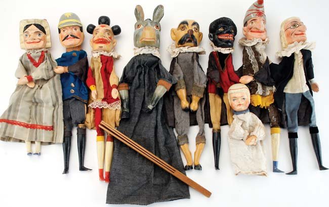 Punch & Judy Puppet Set: 9 piece set with wood and gesso composition faces, hands and lower legs; traditional glove puppet form grouping includes the usual characters such as Punch in his bent sugarloaf hat with slapstick, Ju