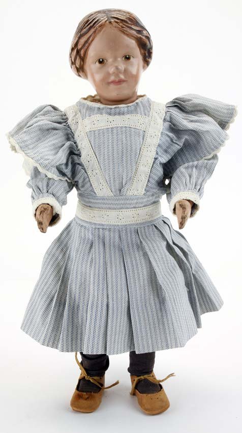Schoenhut Girl with Molded Braids: painted wood, spring jointed model 102 character with intaglio eyes, molded hair with braids wrapped in back with carved bow, nicely redressed, but retains original shoes and decal on back of shoulder