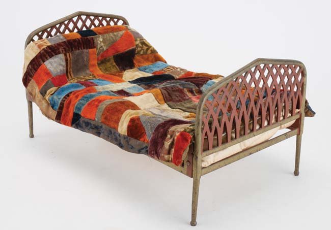 Stevens & Brown Cast Iron Doll Bed: American; painted red and gold with home crafted mattress, coverlet and crazy quilt; ex Goodman House Museum Collection 10.5" w. x 18.5" l. x 9.5" t.