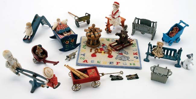 Miniature Dolls & Toys: dolls' house accessories for the playroom or nursery; 8 Arcade and Kilgore cast iron toys including cradle, see saw and slide; 4 jointed bisque baby dolls, alphabet petit point carpet, Nuremberg paint