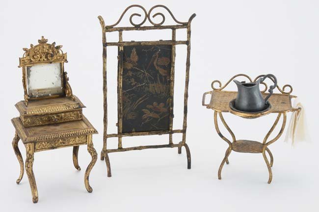 Erhard & Sohne Dolls' House miniatures: ormolu furnishings include screen with printed paper on card insert, tiered dresser and wash stand offered with coin silver basin and pewter pitcher; ex Goodman House Museum Collection screen 3.5" w. 