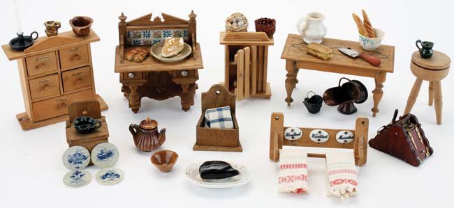 Dolls' House Kitchen Furnishings: miniature grouping includes printed design table, spice drawers, towel rack and egg cabinet in German signage, chopping block with cleaver, side table with printed paper back replicating ceramic tile,