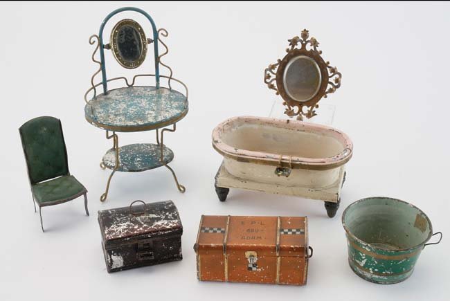 Tin Dolls' House Furniture & Trunks: early painted tin grouping includes decorative wall hanging, Stevens & Brown chair, wash stand with mirror (attributed to Plank) German pail & bath tub and 2 trunks (larger by Lehmann) stand 7.5" t.