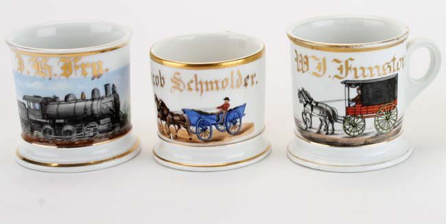 Transportation Themed Occupational Shaving Mugs - 3: P.R.R. railroad (T & V Limoges France) along with 2 unmarked horse drawn theme mugs: an early hearse type vehicle (small chip on base) and an open wagon (hairline in handle) appr. 3.5" t. each