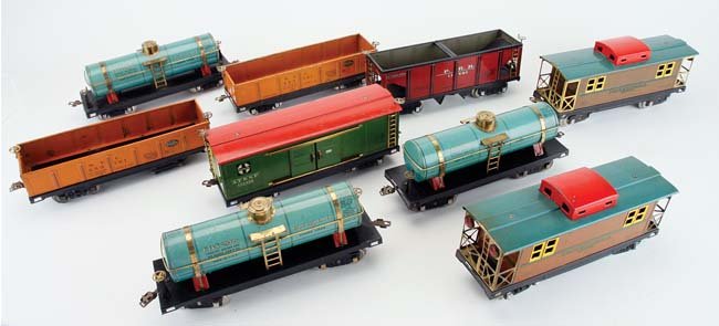 Nine Dorfan Wide Gauge Freight Cars: lithographed and painted tin railway cars include two 806 cabooses, 805 hopper, 801 box car, two 800 gondolas (1 needing wheels reattached) and three 804 tank cars appr. 13" l.
