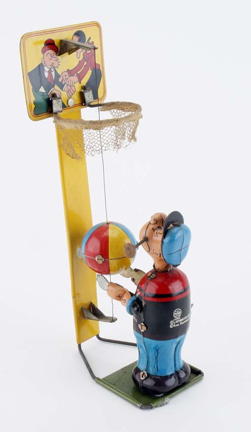 Linemar Popeye Playing Basketball: lithographed tin, depicts Popeye shooting ball up through hoop again and again, a nice all original example 9" t.