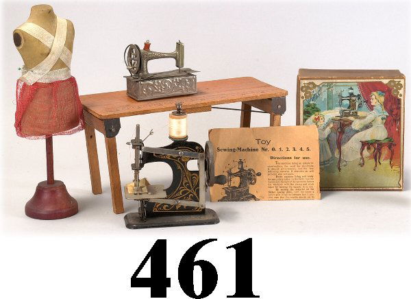 Lot: Sewing Table & accessories: doll's oak collapsiable sewing table with printed ruler and the words"Junior Seamstress", together with doll size tiny working sewing machine in original box with directions and another small scale do