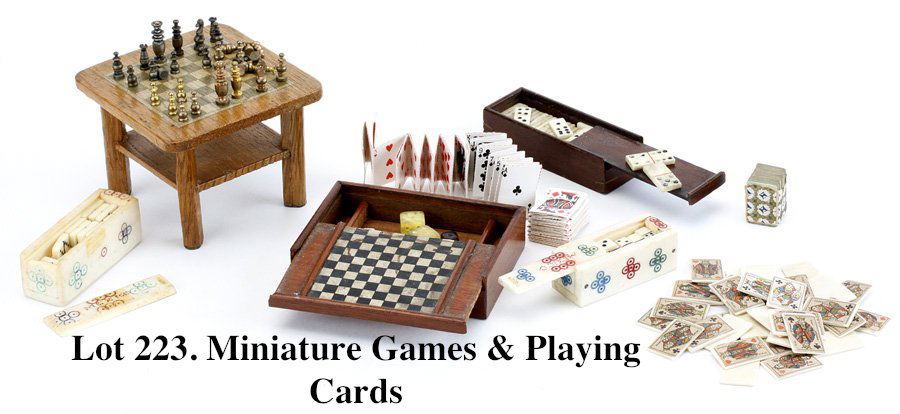 Miniature Games & Playing Cards: included are 3 bone, stone and wood domino sets, various playing cards with carved bone card holder, dice, game table and chess set in lithographed paper on wood game box. Ex FGJ Collection table 2.75