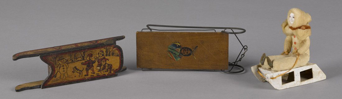 Three miniature wooden sleds, one with a decal (1 of 1)